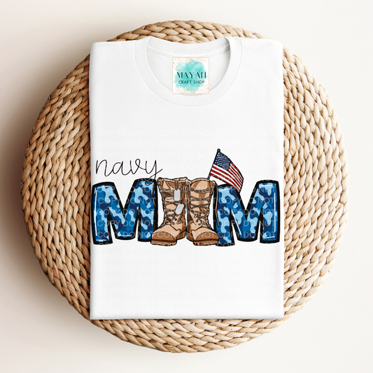 White t-shirt with military mom design featuring boots and an American flag on a woven mat.