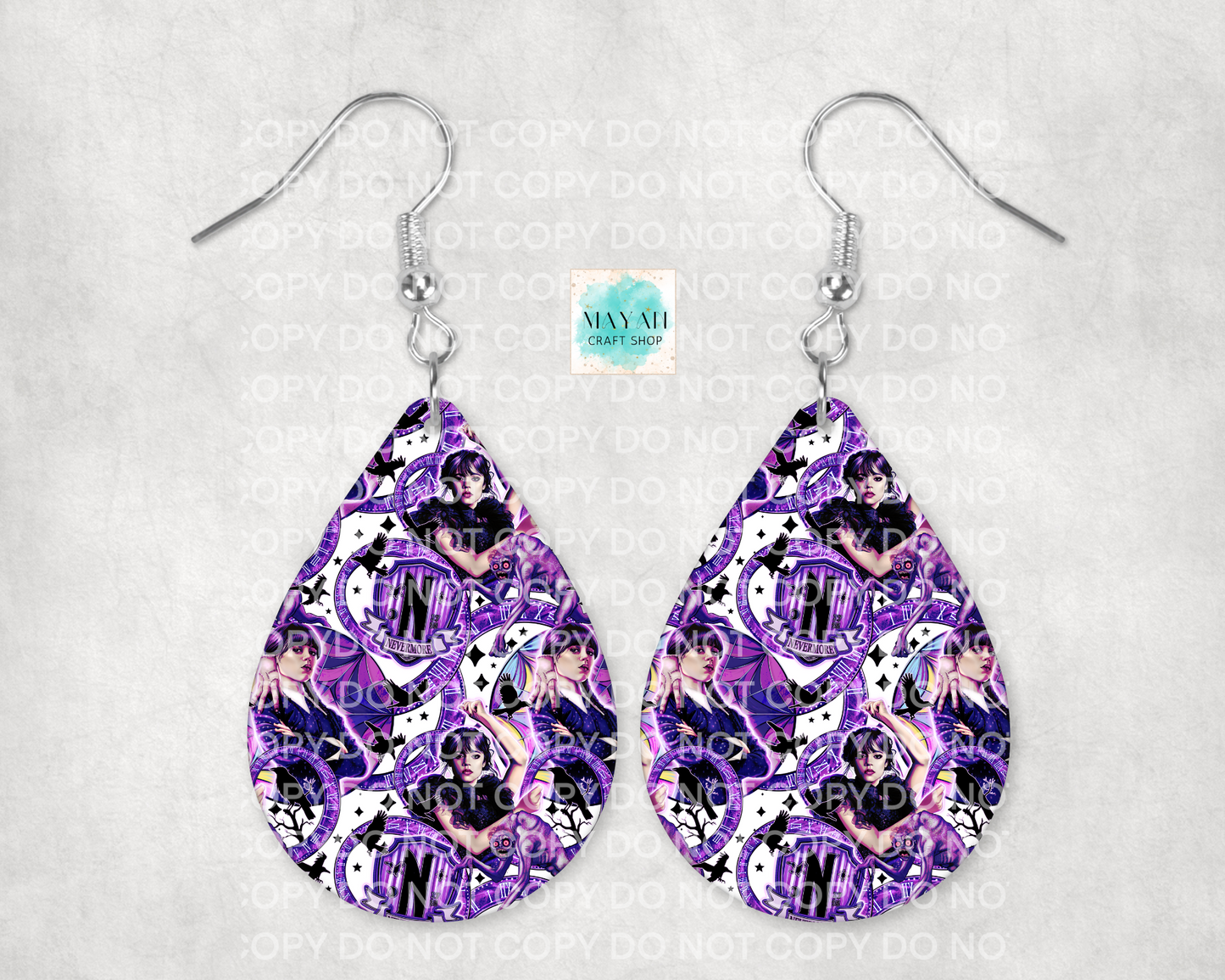 Teardrop-shaped earrings with purple and black pattern on a gray background