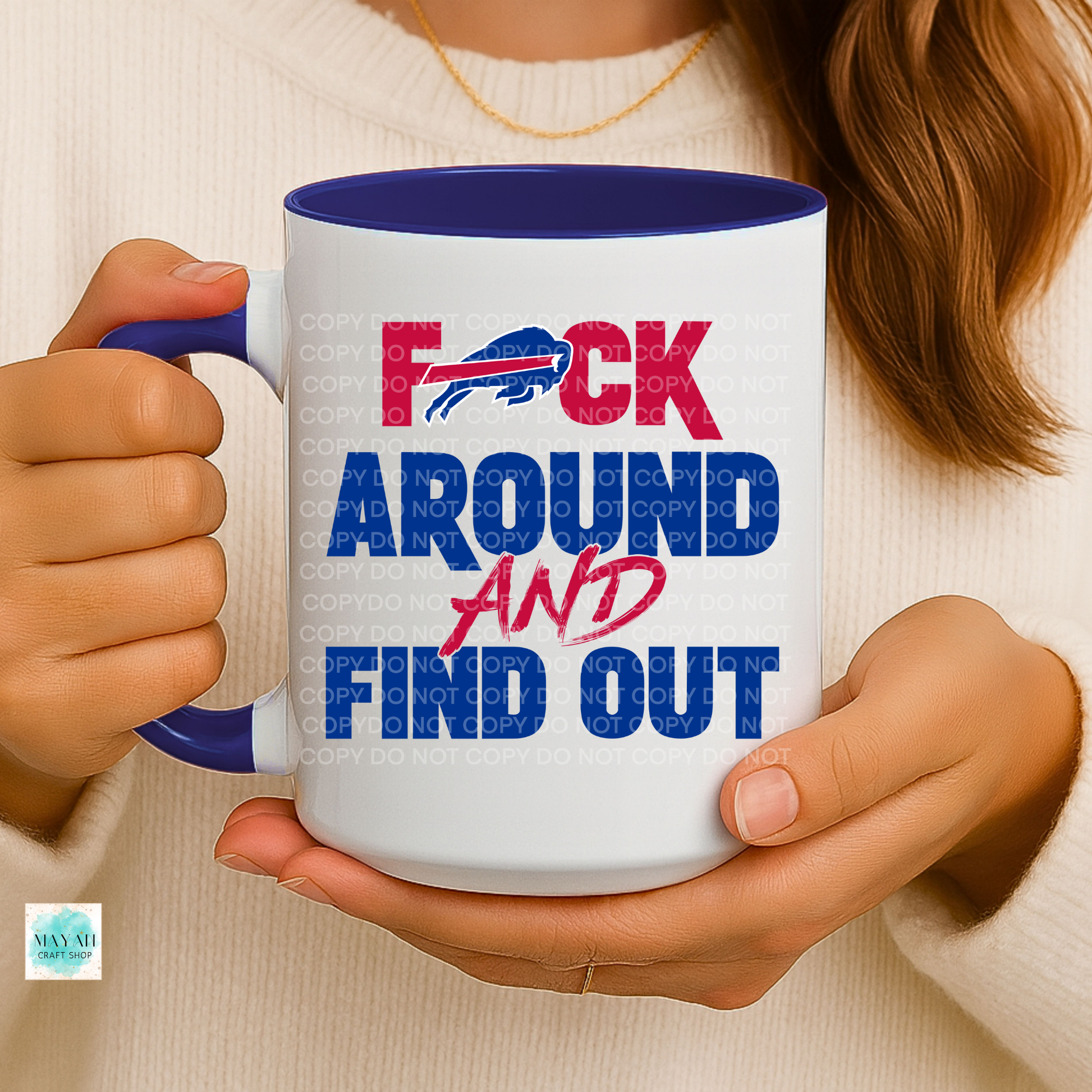 Person holding a mug with text and logo, brand visible