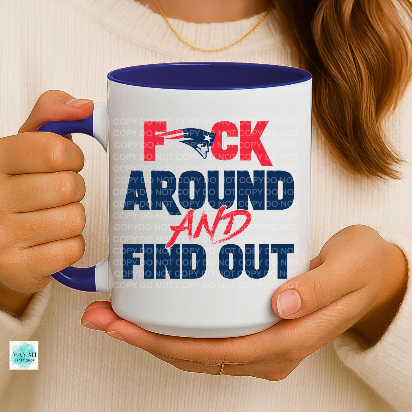 Person holding a mug with a graphic design and text.