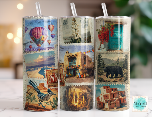 Three cylindrical tumblers with scenic designs on a blurred background