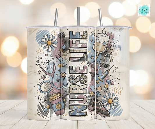Tumbler with 'Nurse Life' design featuring medical symbols and flowers on a blurred background.