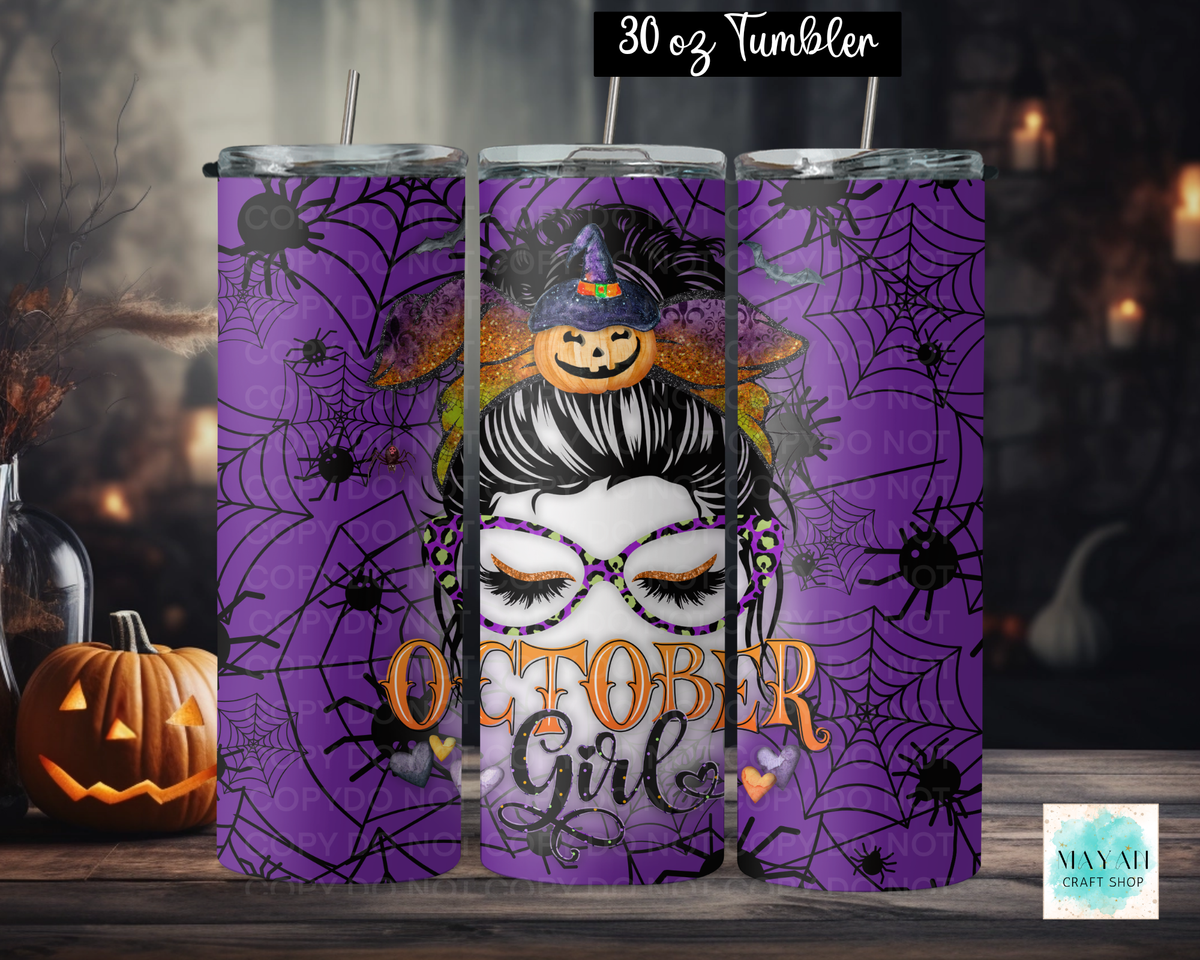 Three views of a 30 oz stainless steel tumbler with a purple Halloween design featuring spiderwebs, a witch hat with a jack-o'-lantern, and the words 'October Girls'. The tumbler is shown on a wooden table next to a jack-o'-lantern with a spooky background.