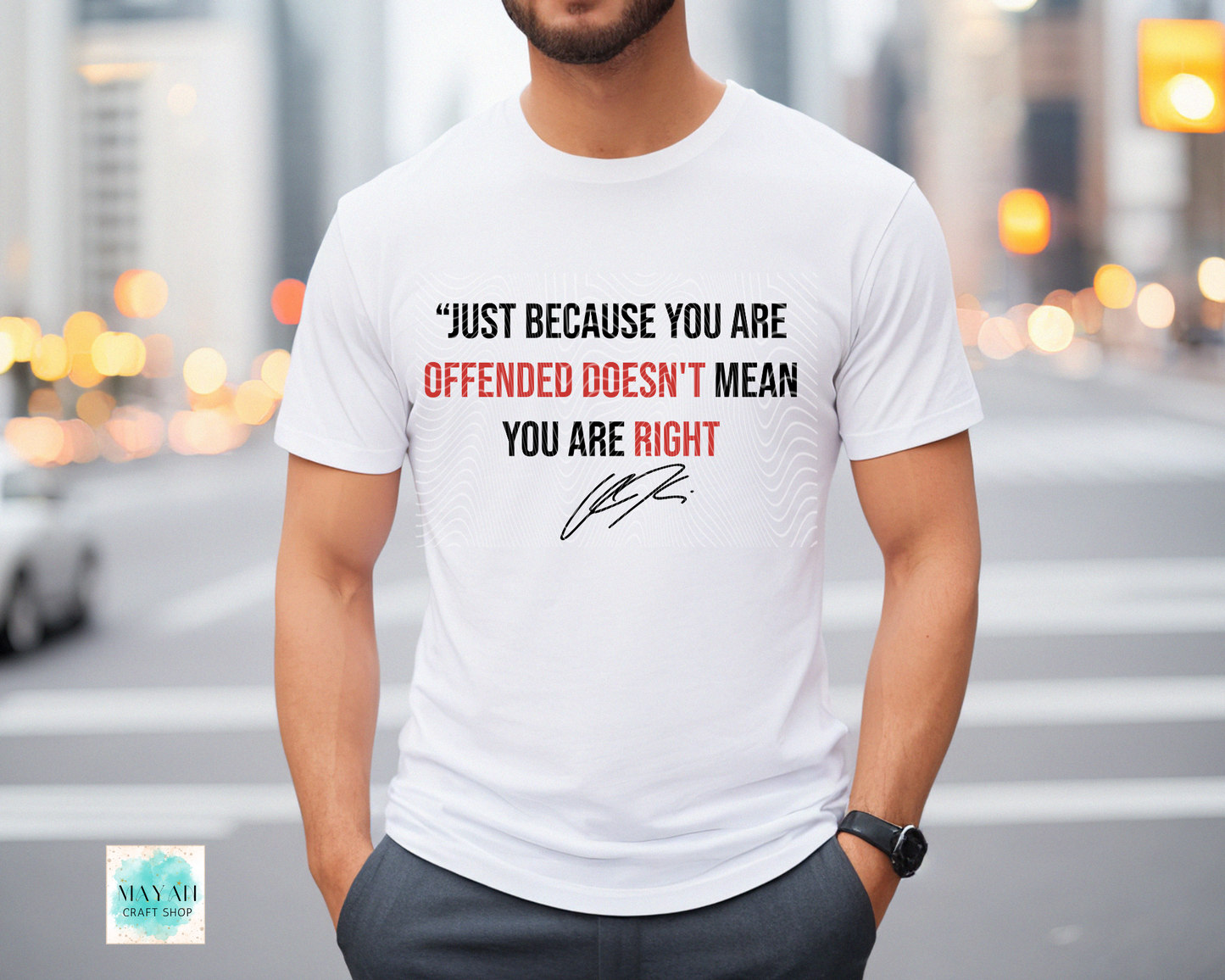 Person wearing a white t-shirt with a motivational quote in an urban setting