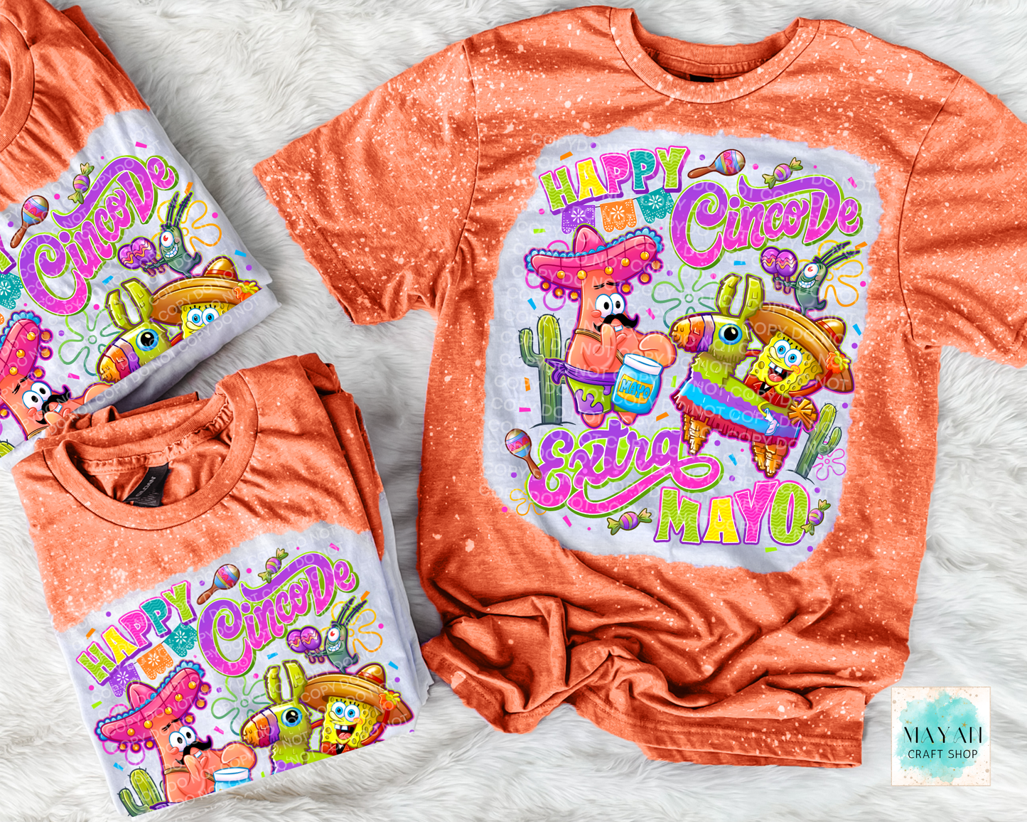Two orange t-shirts with 'Happy Cinco De Mayo' design on a light gray background.
