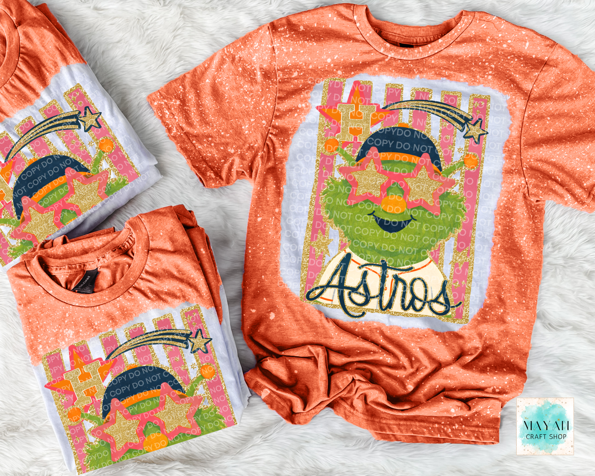 Orange t-shirt with colorful graphic design on a textured surface