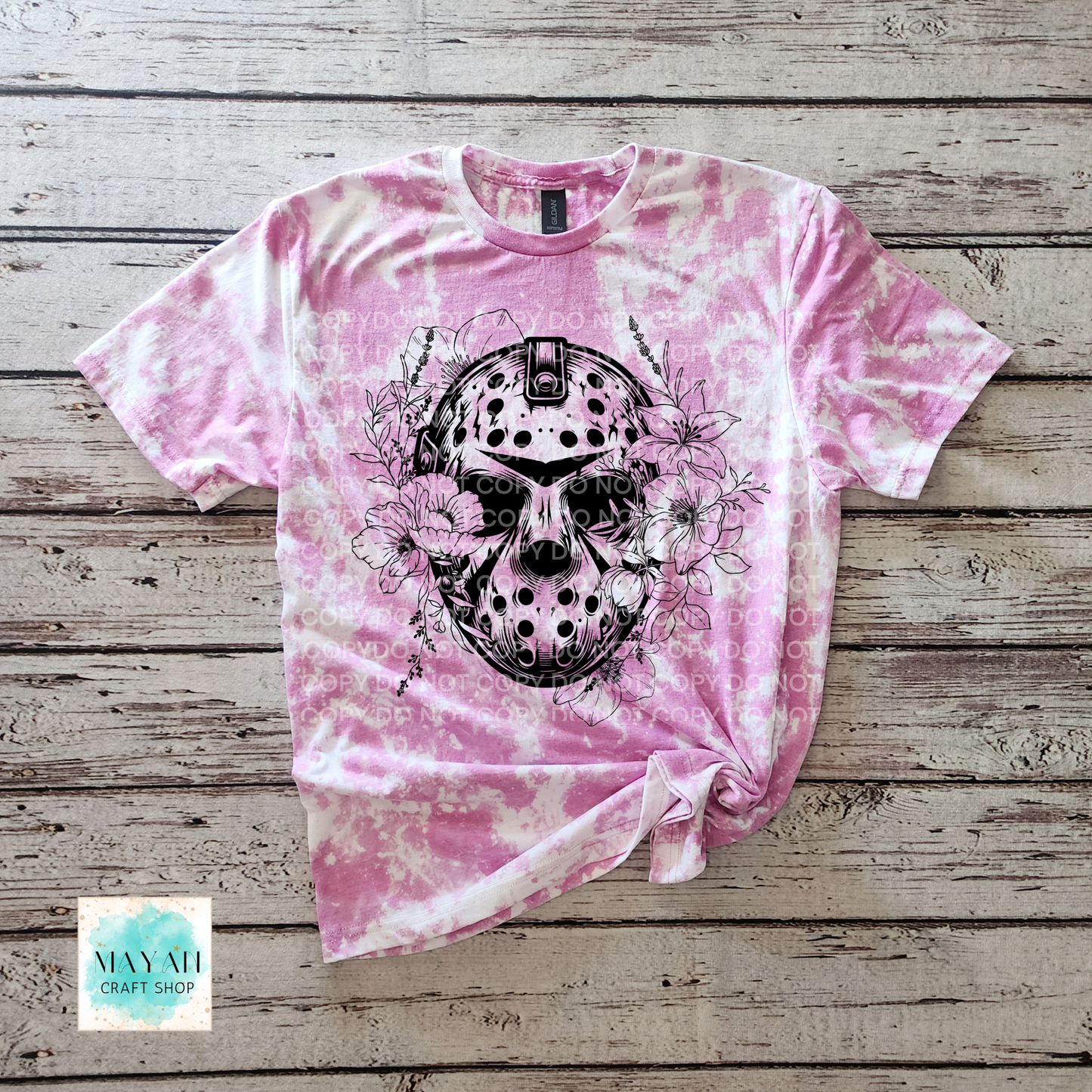Pink tie-dye t-shirt with a black skull design on a wooden surface, branded 'May All Craft Shop'.