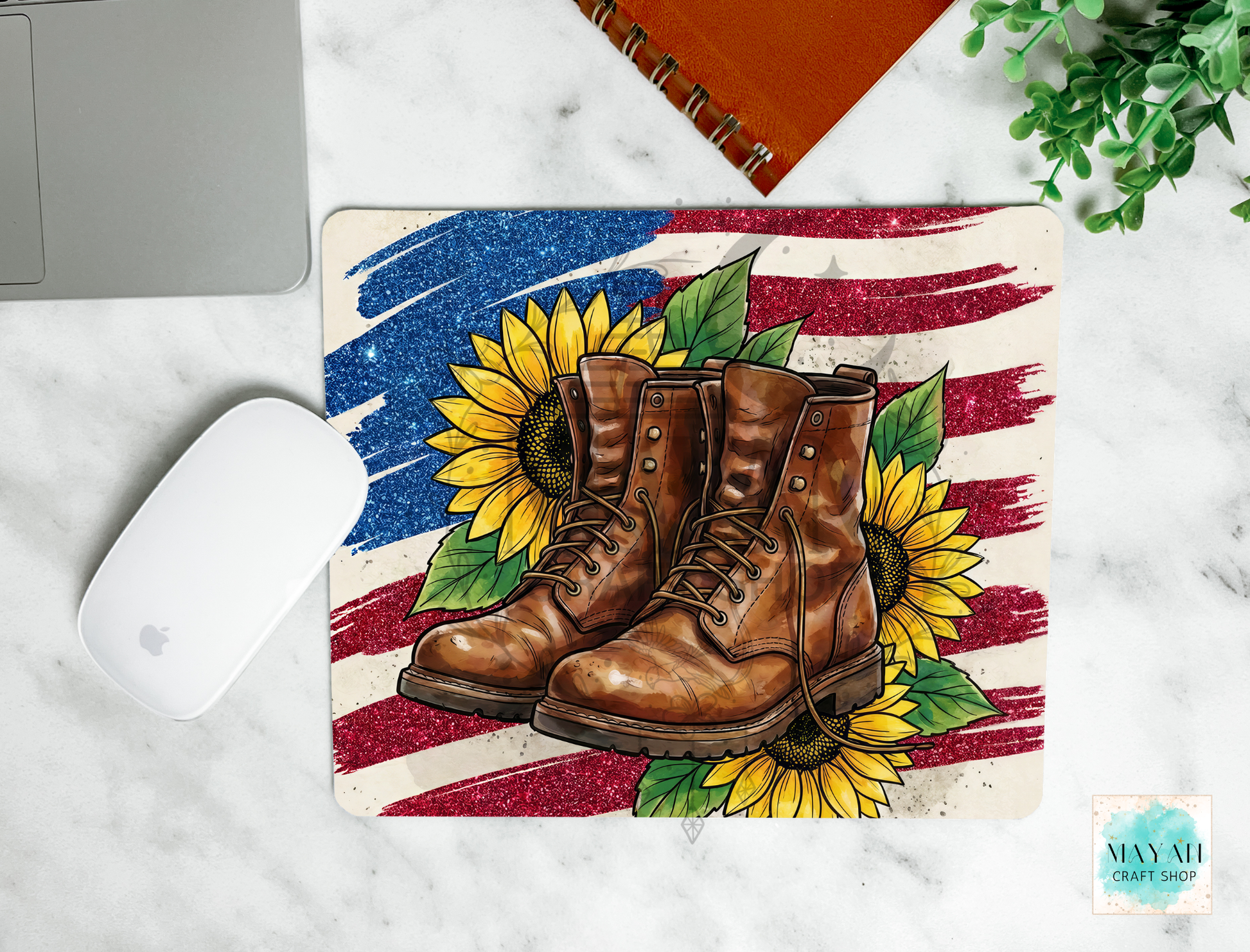 Mouse pad with boots, sunflowers, and American flag design on a marble surface.