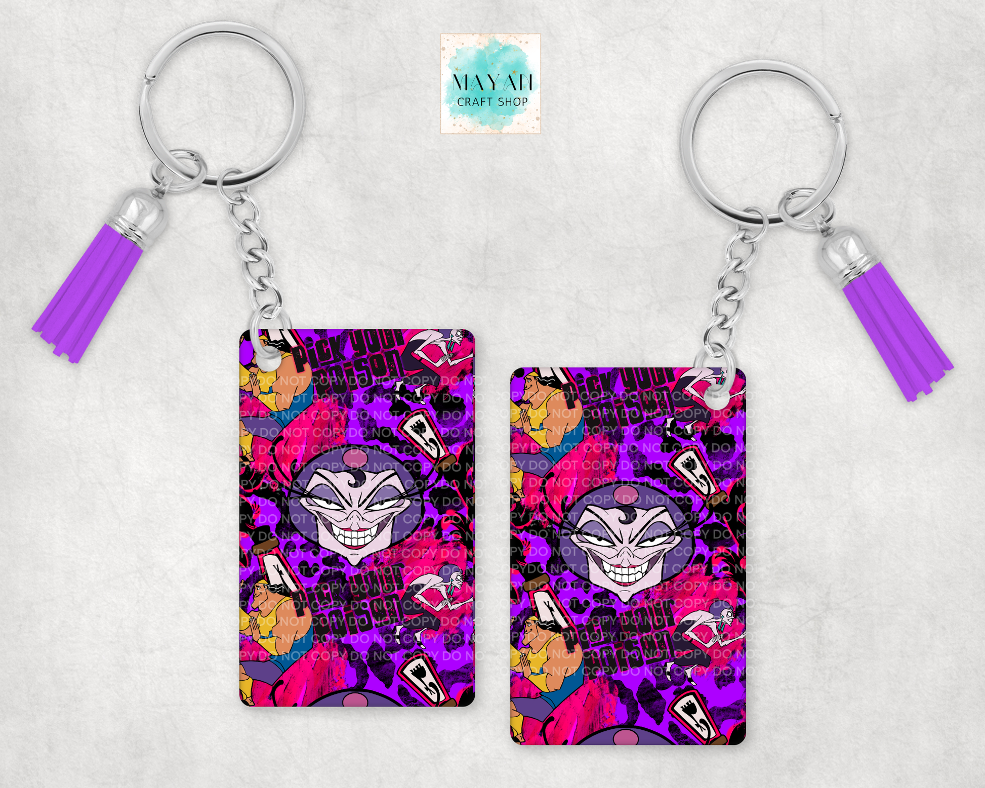 Two keychains with a colorful design featuring a face and tassels on a light gray background.