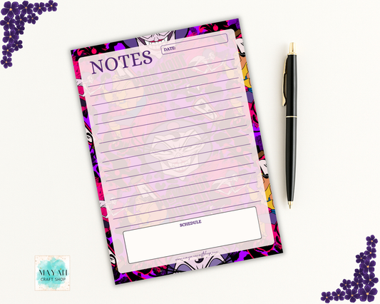 Notepad with colorful design and pen on a white background