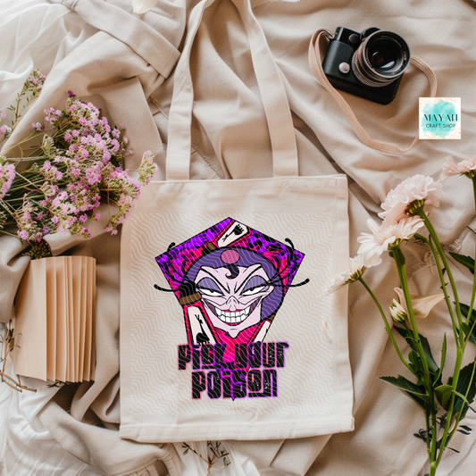 Tote bag with a colorful design and text on a soft fabric background with flowers and a camera.