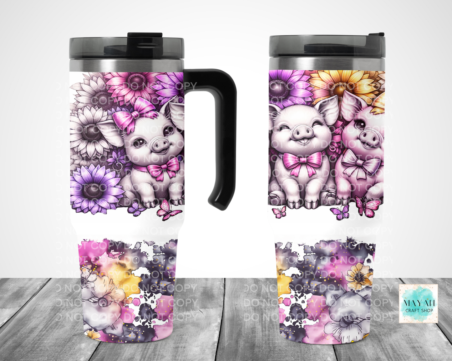 Set of travel mugs with cute pig illustrations and floral designs on a wooden surface.