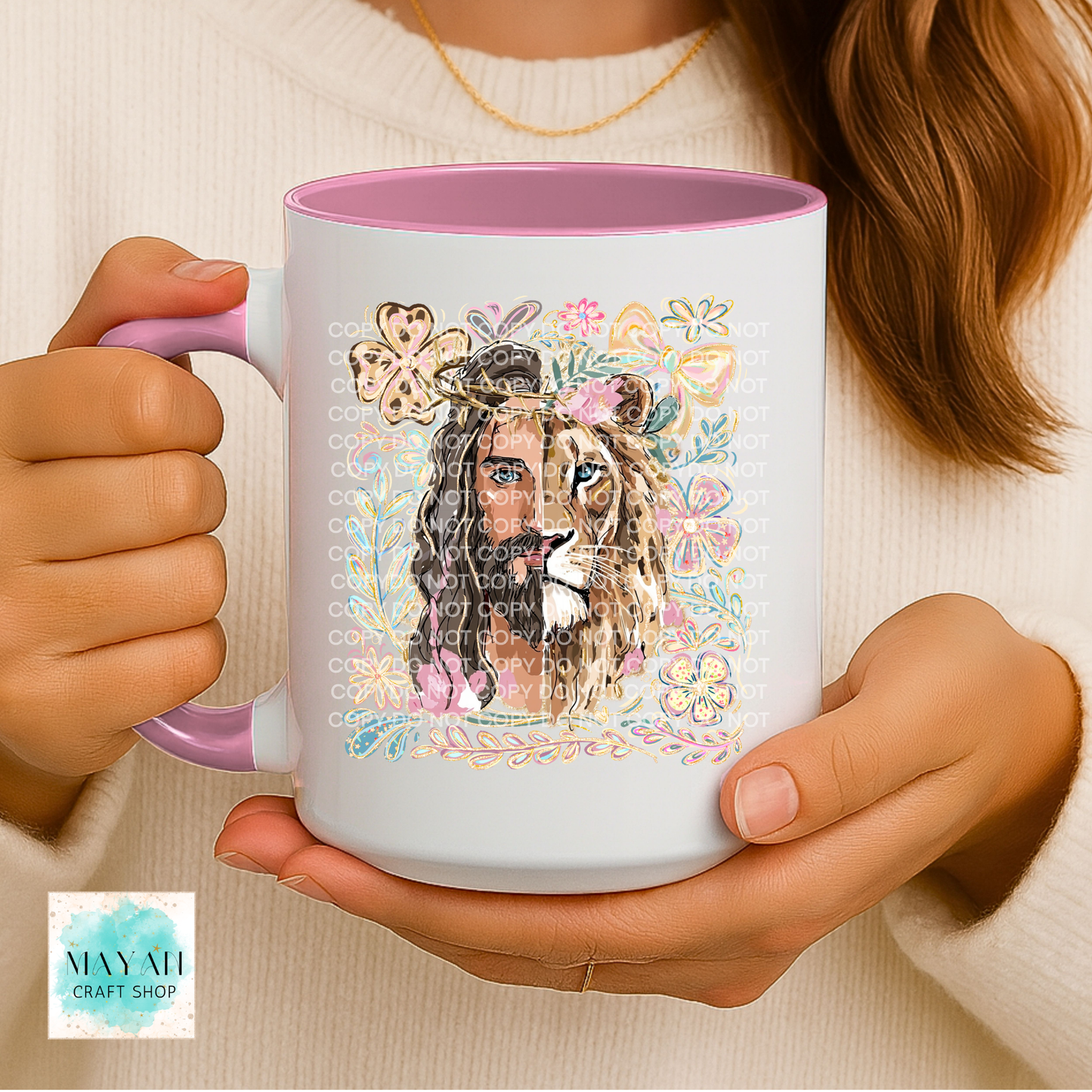 Person holding a mug with a colorful design of a lion and floral elements, featuring the brand 'May All Craft Shop'.