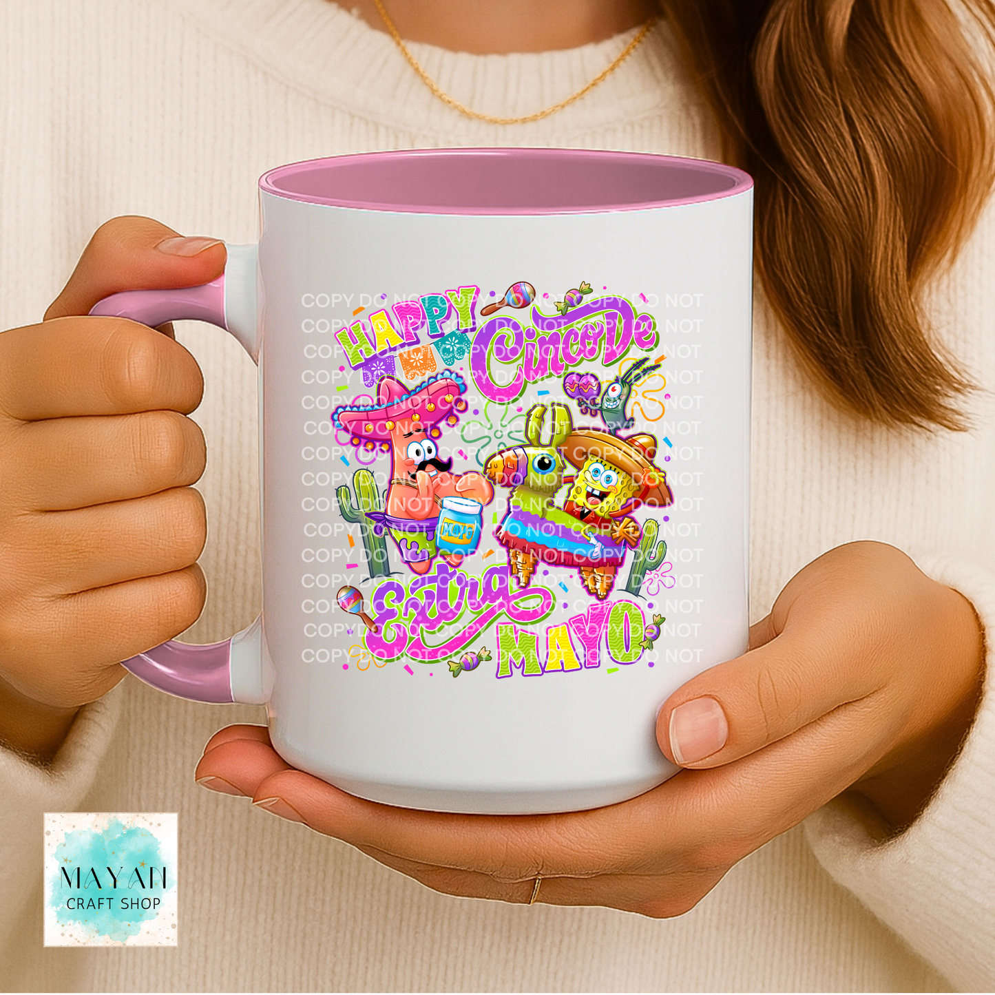 Person holding a mug with colorful 'Happy Cinco de Mayo' design