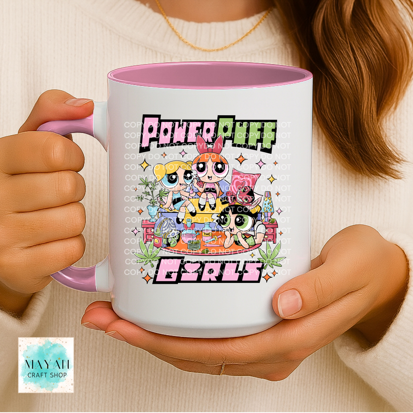 Person holding a mug with a vibrant design, featuring cartoon characters.