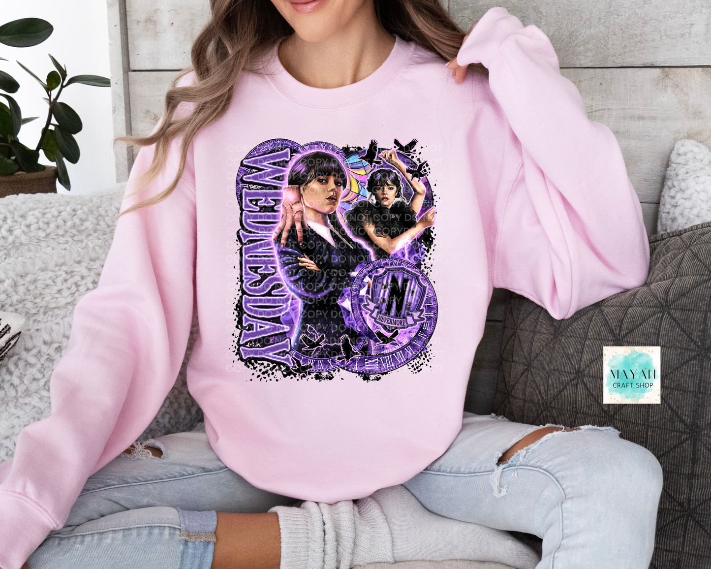 Purple design on light pink sweatshirt.