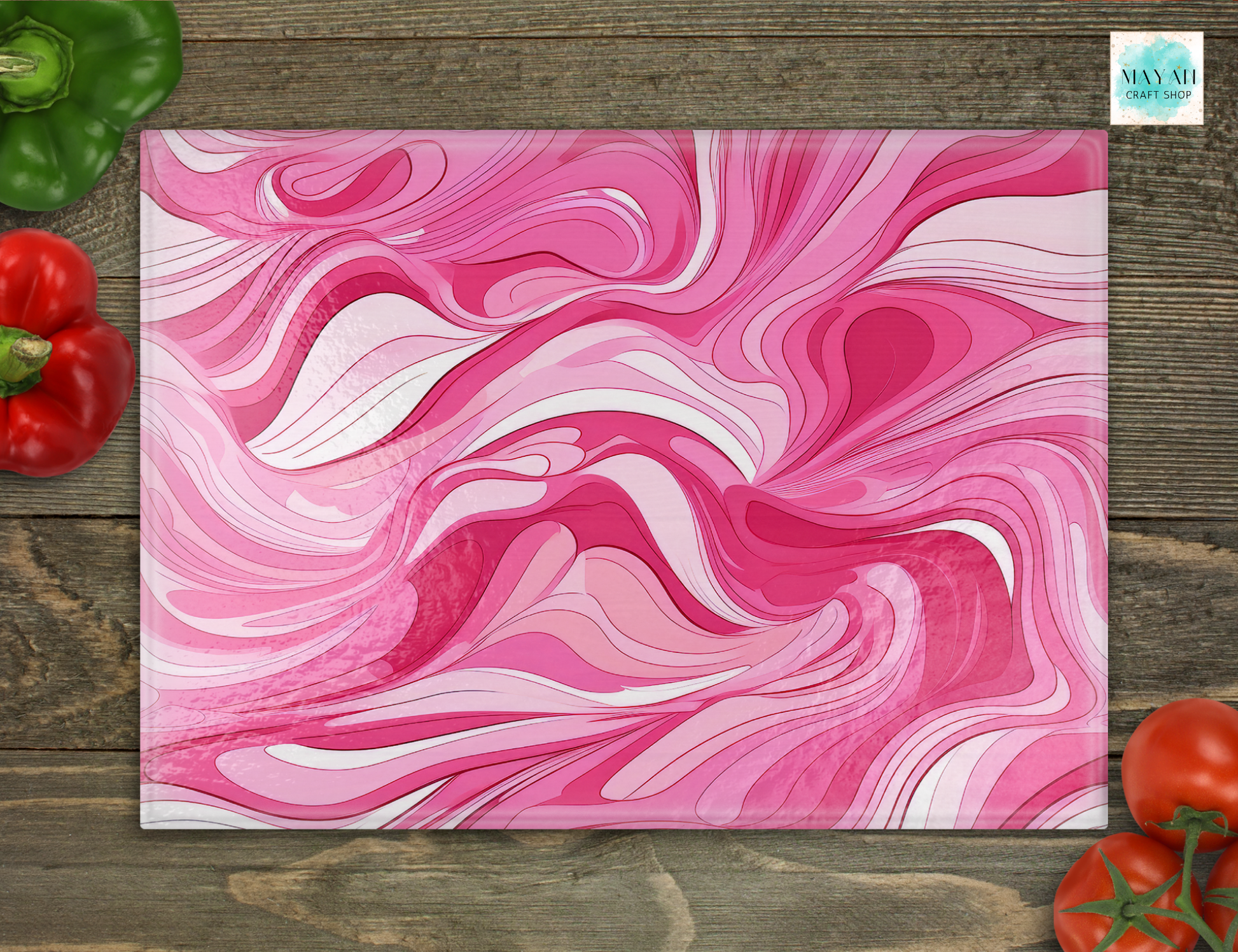 Pink and white marbled cutting board on a wooden surface with vegetables.
