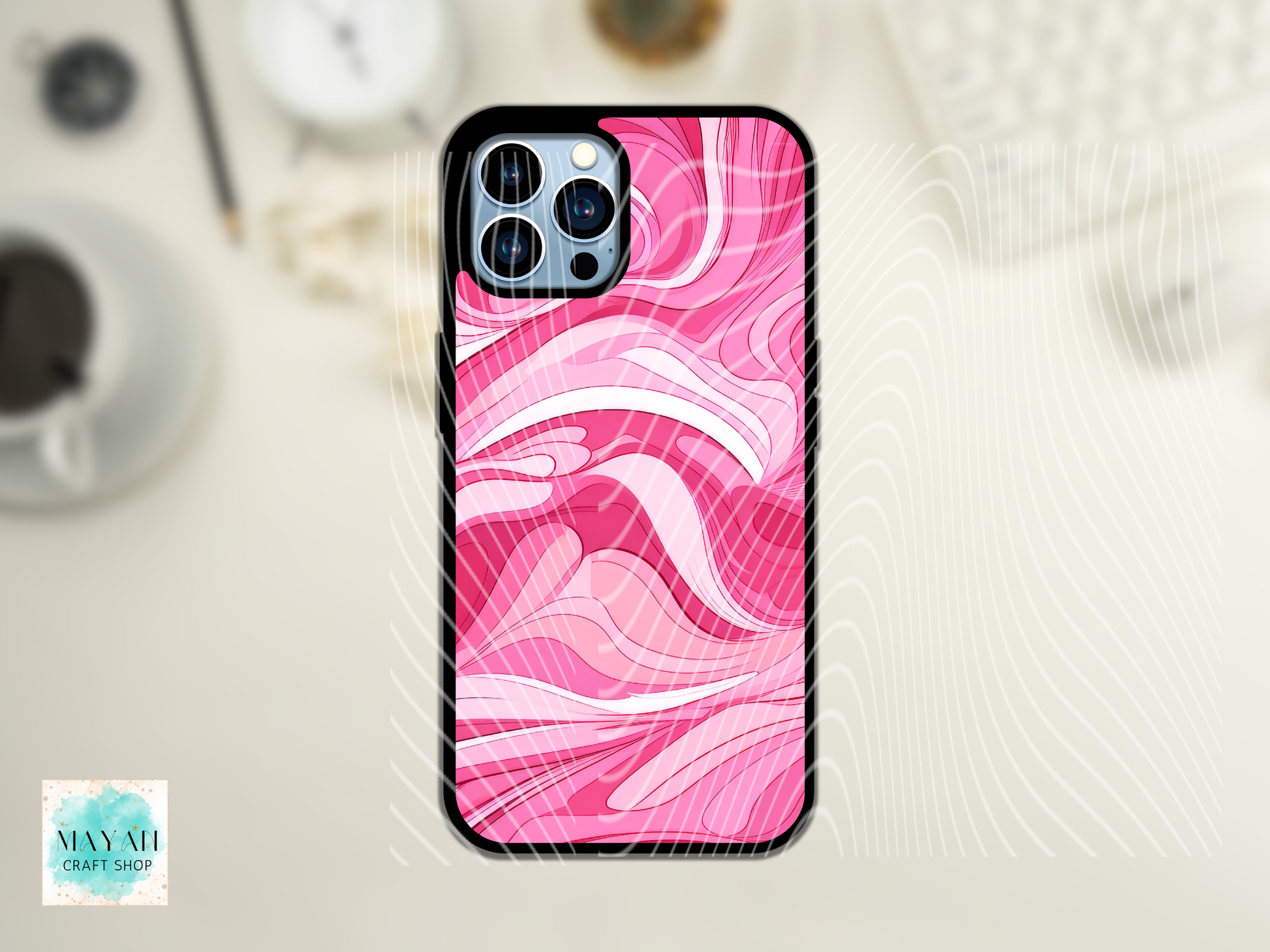 Phone case with pink and white marble pattern on a light surface