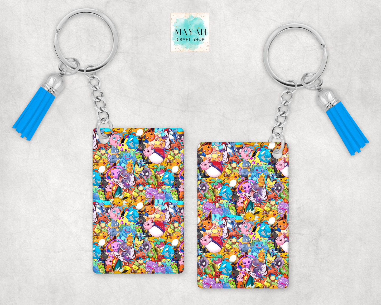 Keychains with colorful pattern and blue tassels on a light gray background