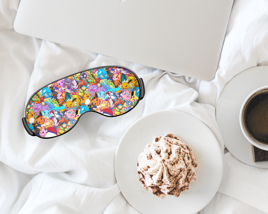 Colorful sleep mask on a white surface with a plate of food and a cup of coffee.