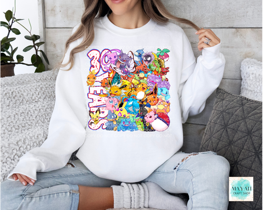 Person wearing a white sweatshirt with colorful graphic design sitting on a couch.