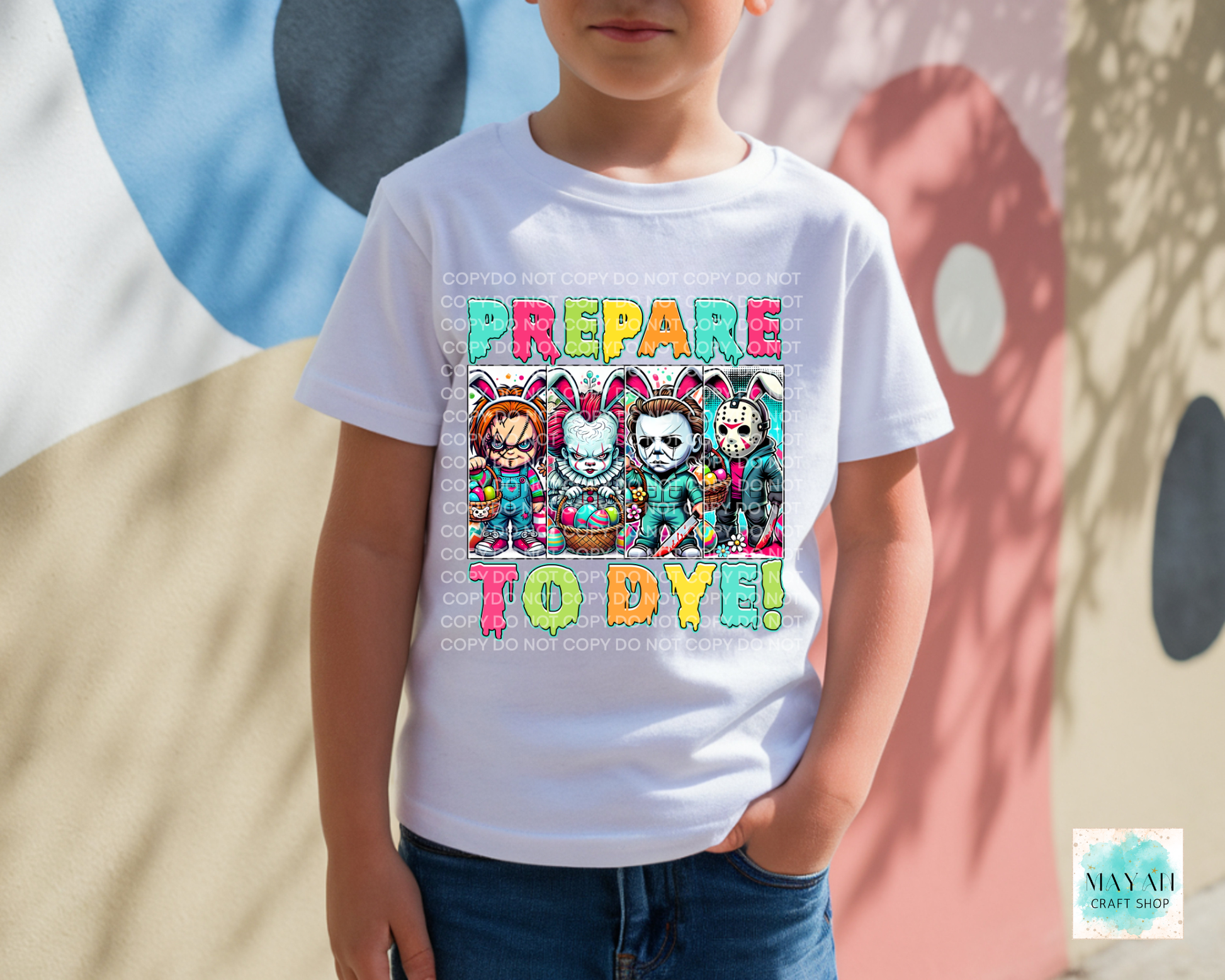 Child wearing a white t-shirt with colorful graphic and text, standing against a multicolored abstract background.