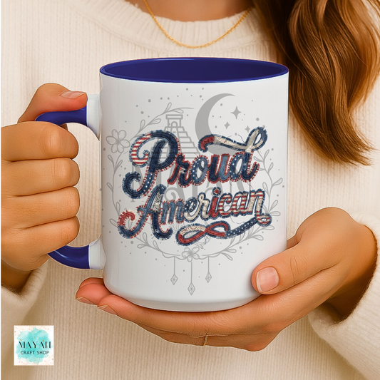 Person holding a mug with 'Proud American' design