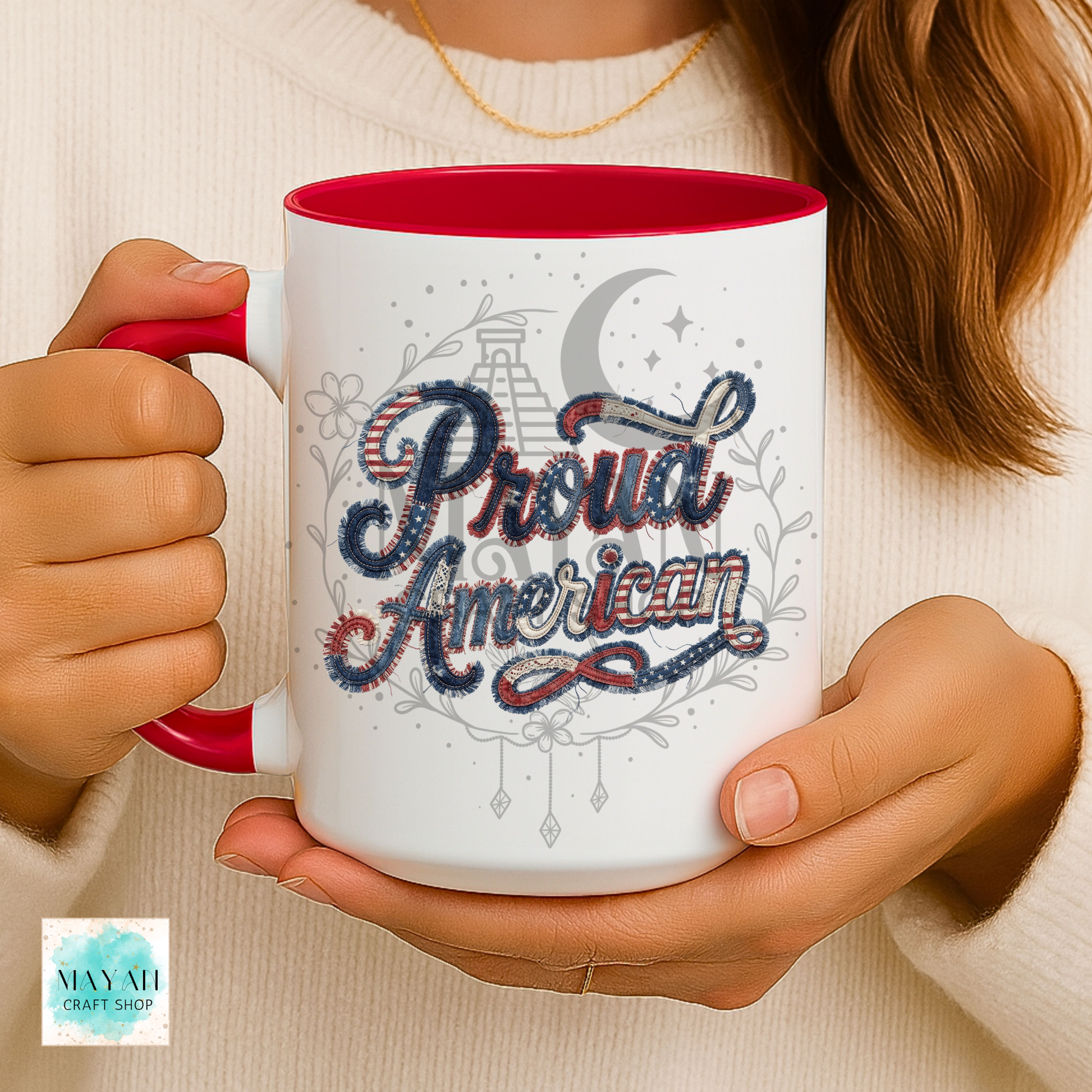 Person holding a mug with 'Proud American' design