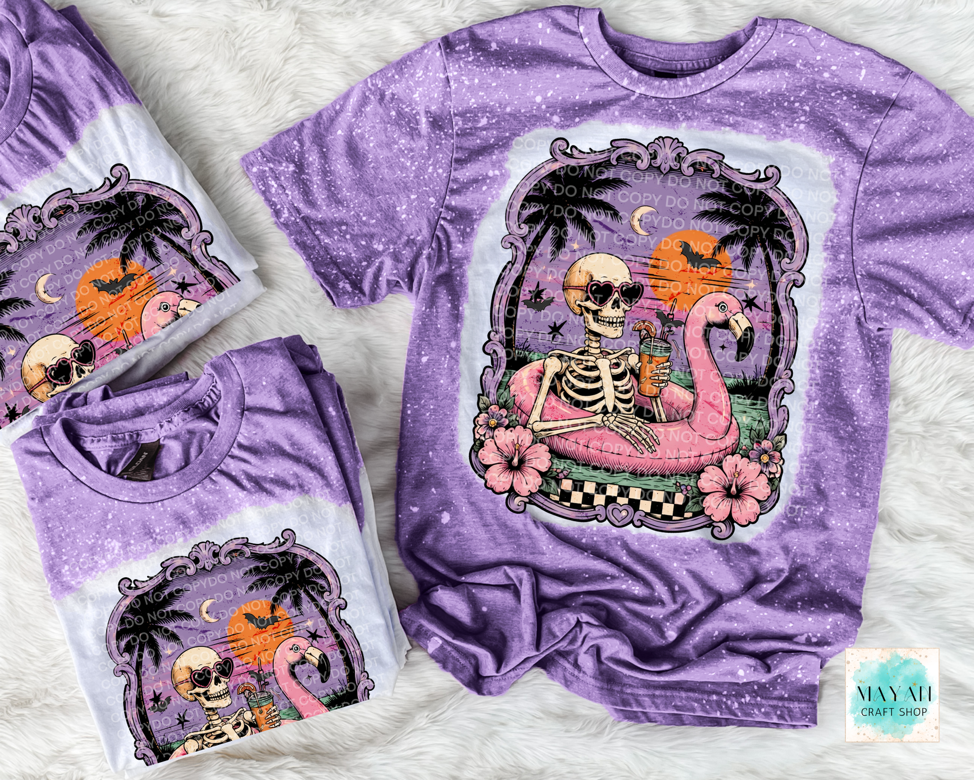 Purple t-shirt with a skeleton and flamingo design on a textured surface