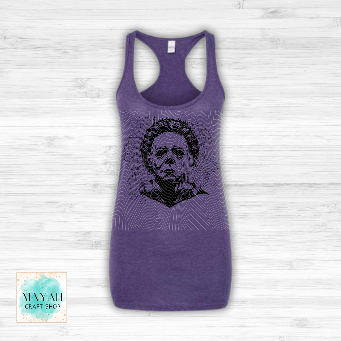 Purple tank top with black graphic design on a white wooden background