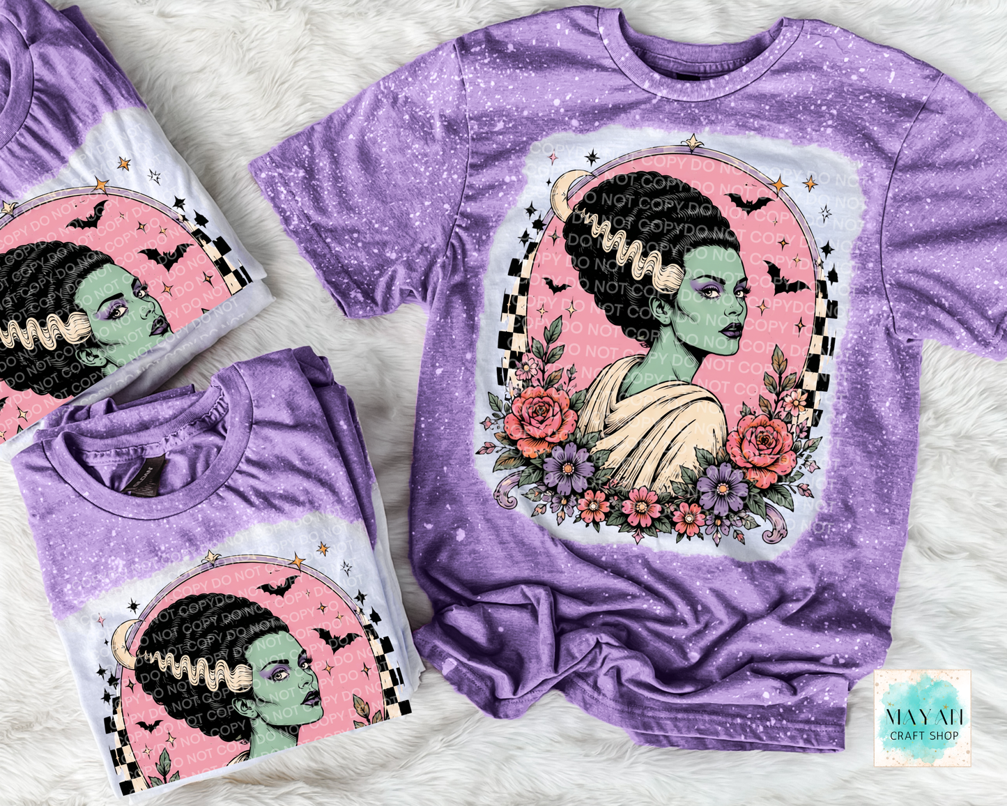 Purple t-shirt with a graphic design of a woman with green skin, flowers, and text on a white background.