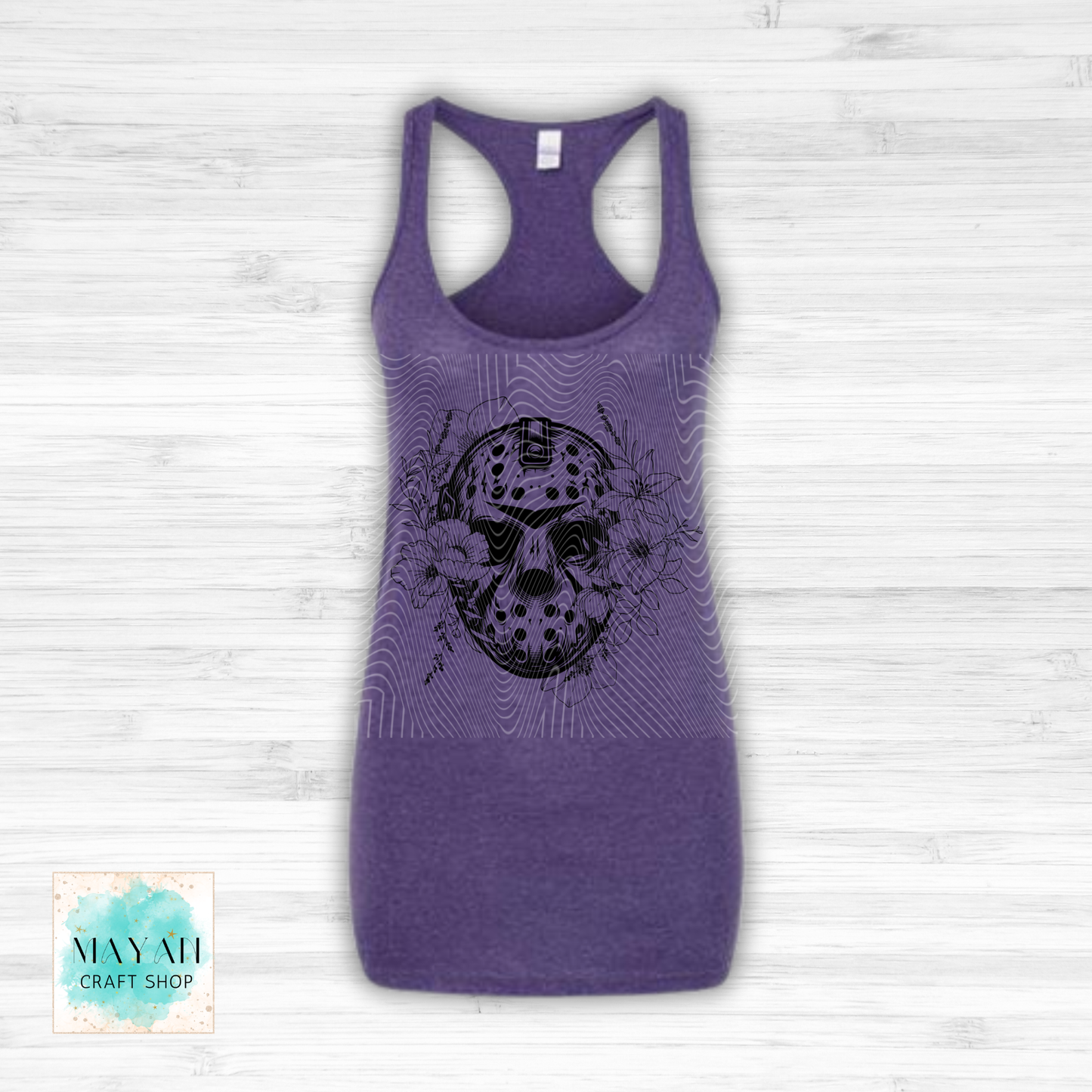 Purple tank top with a black skull design on a white wooden background