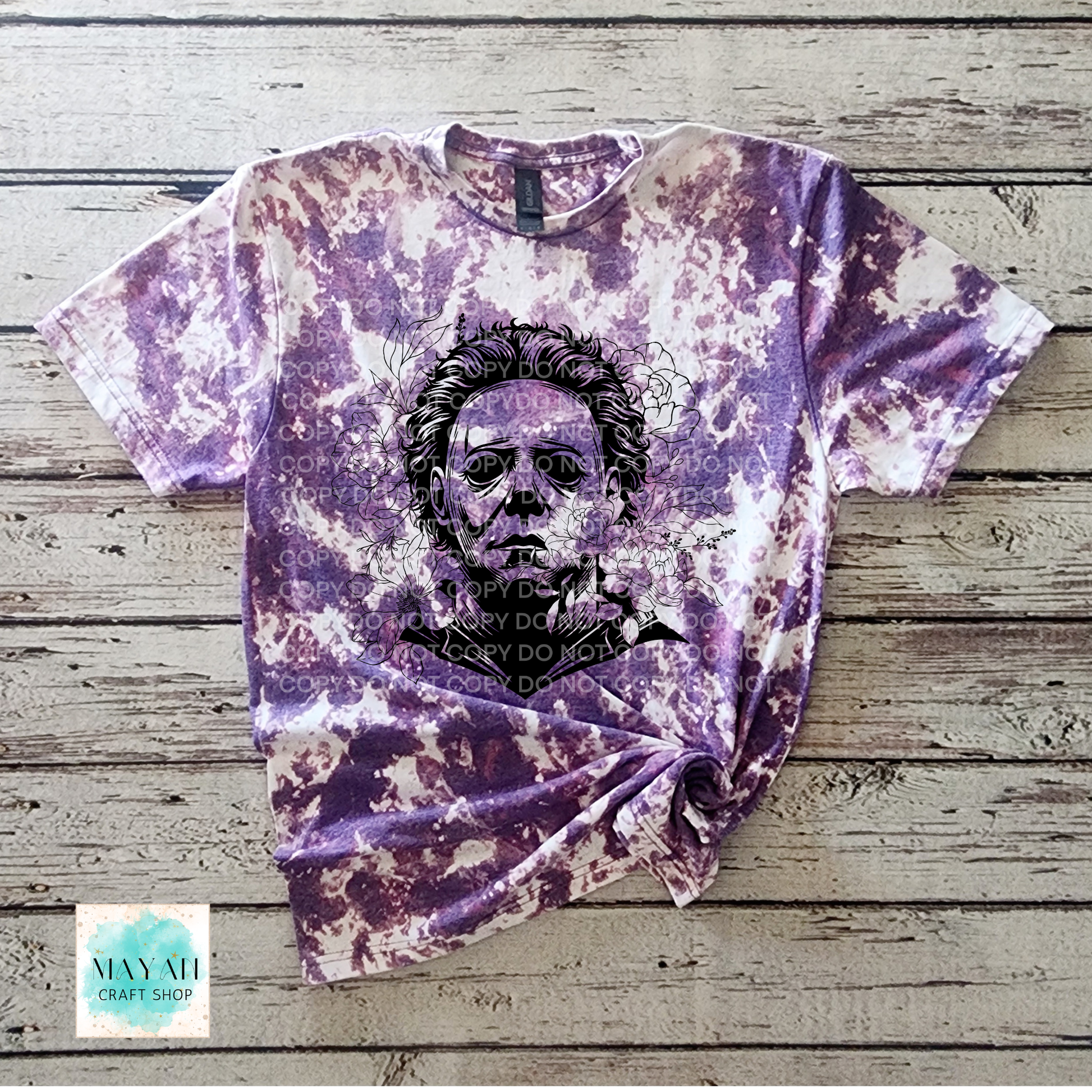 Bleached t-shirt with a graphic design on a wooden surface.