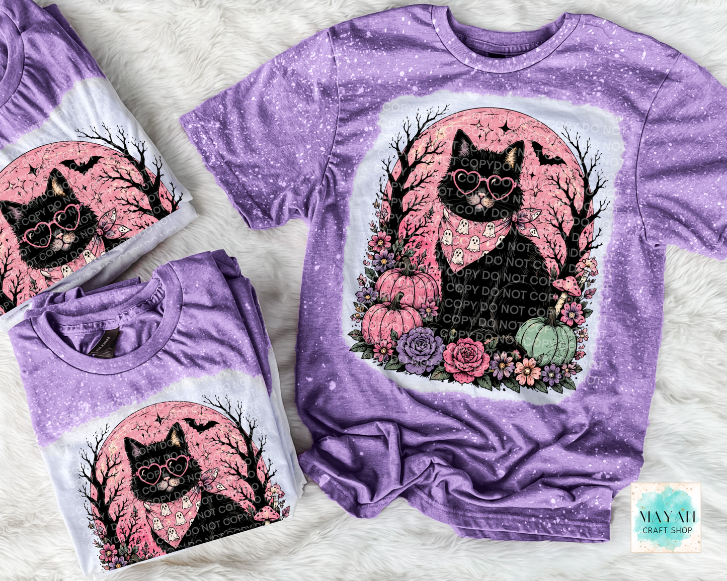 Purple t-shirt with a black cat design on a white background