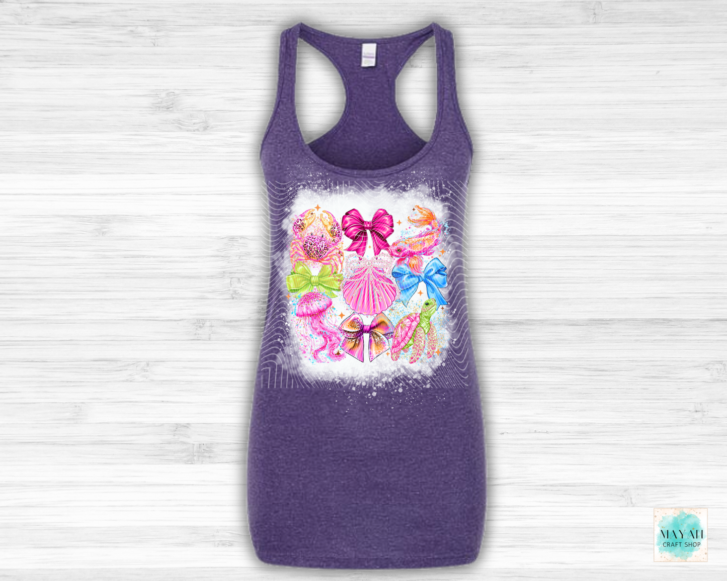 Purple tank top with colorful bow design on a light wooden background