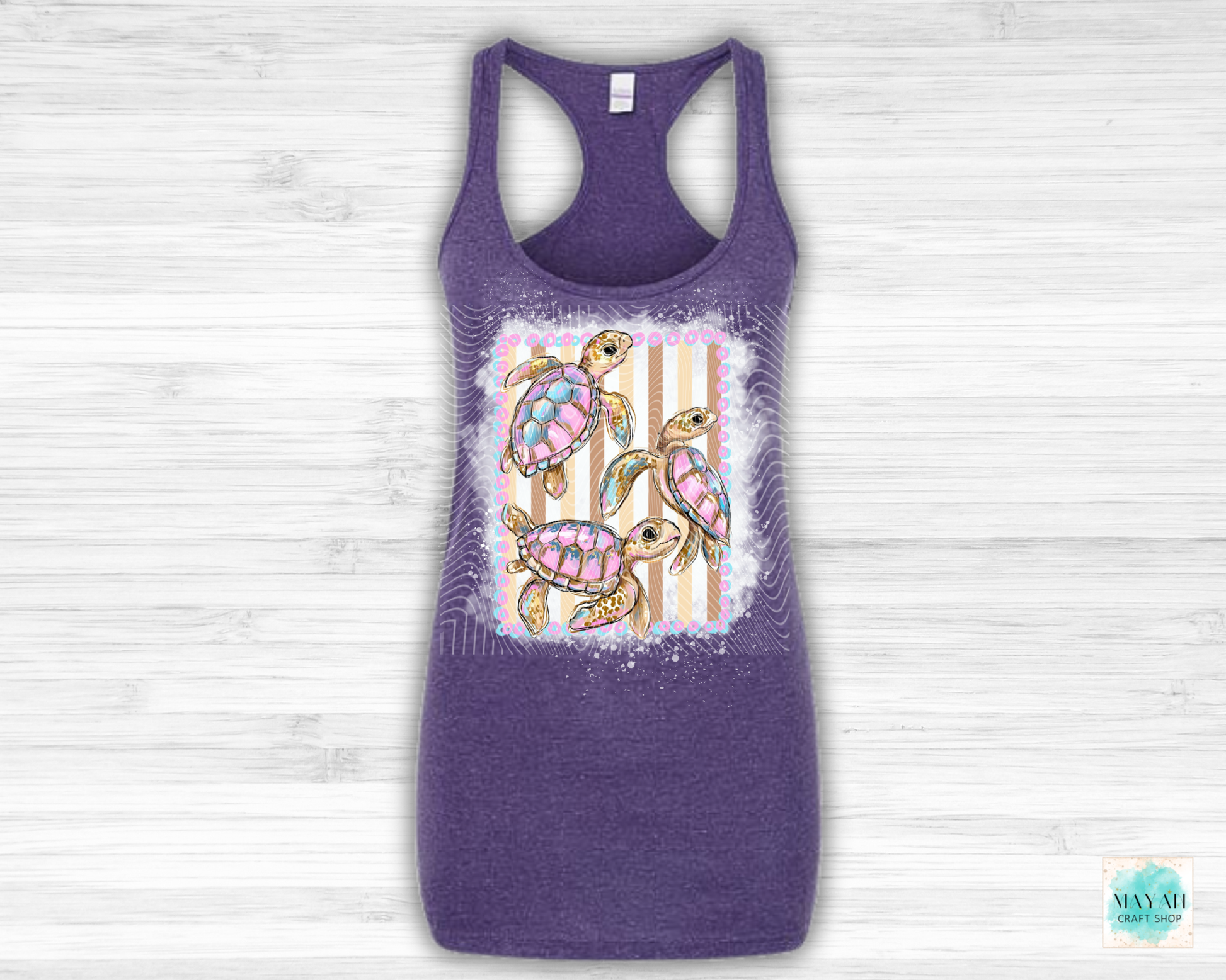 Purple tank top with a colorful turtle design on a light wooden background