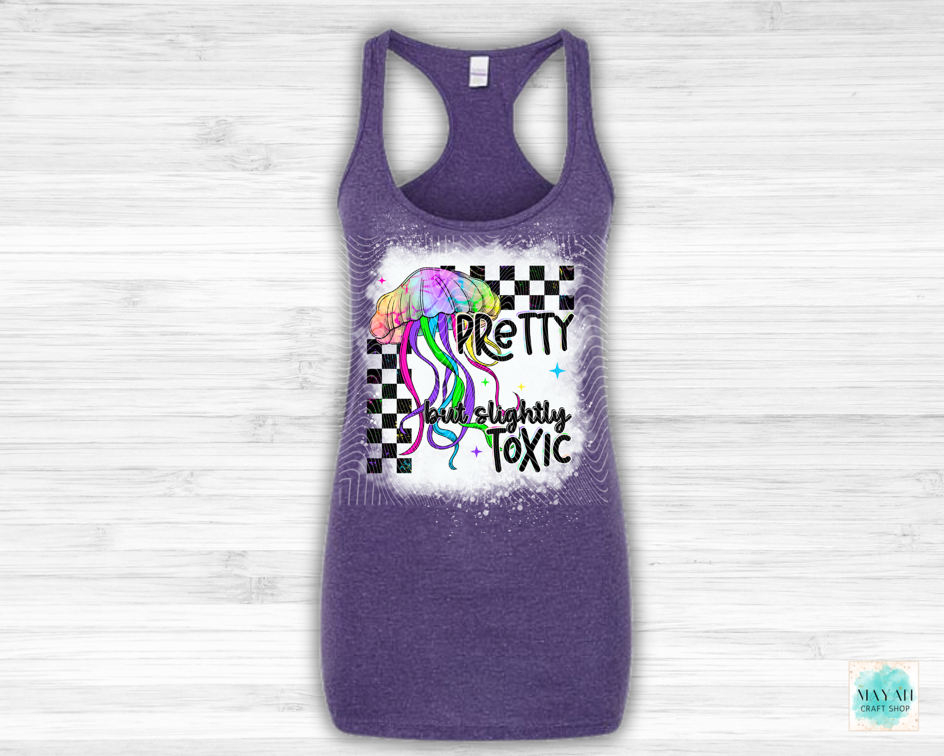Purple tank top with colorful graphic and text on a light wooden background