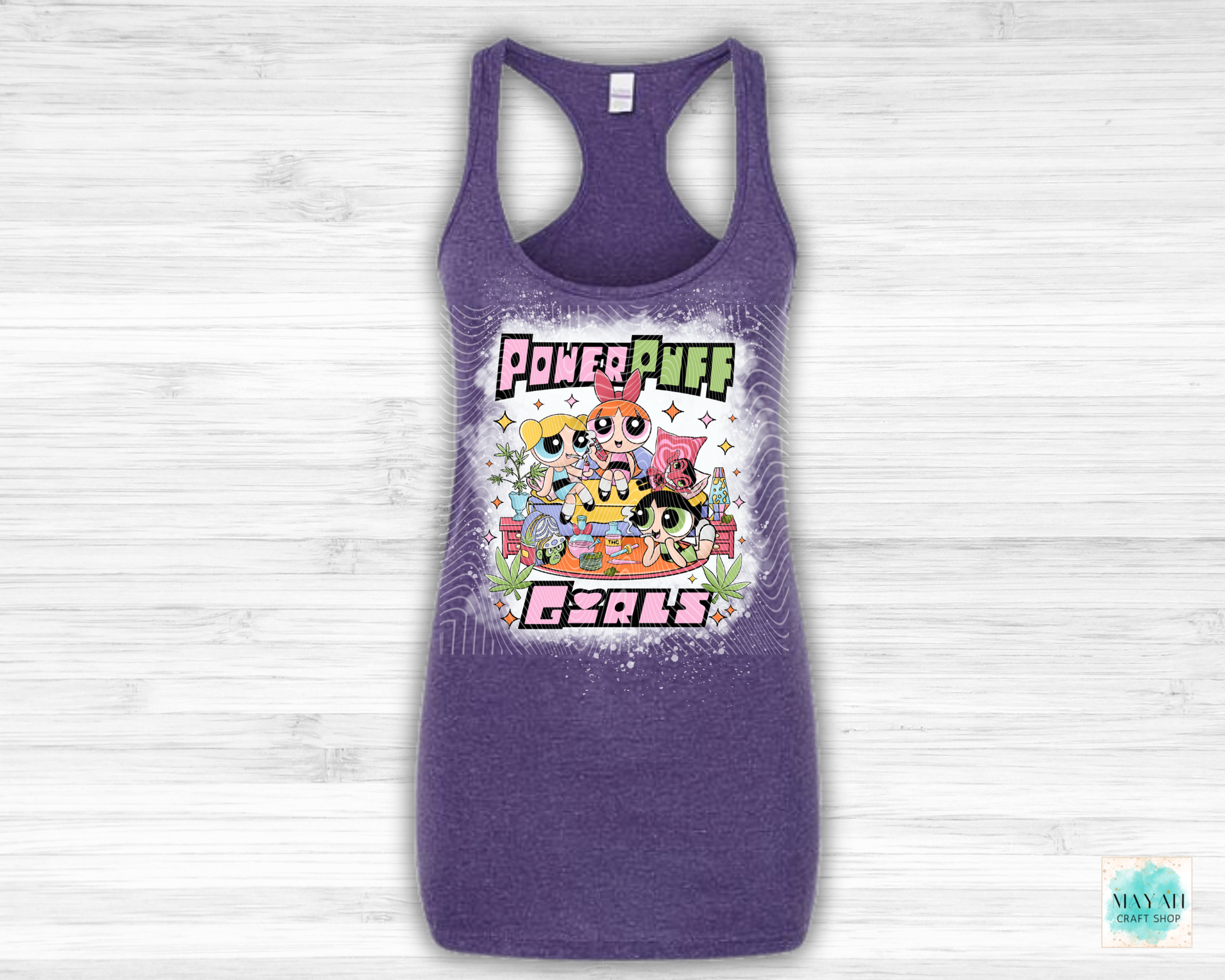 Purple tank top with vibrant graphic on a light wooden background
