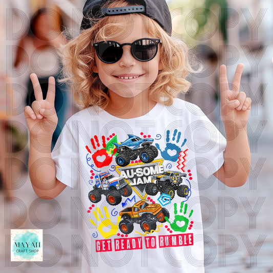 Child wearing a white t-shirt with colorful monster truck design and peace signs.