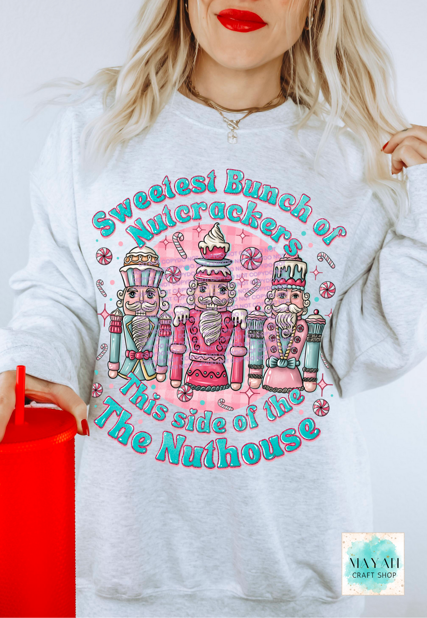 White sweatshirt with Nutcracker design and text, worn by a person.