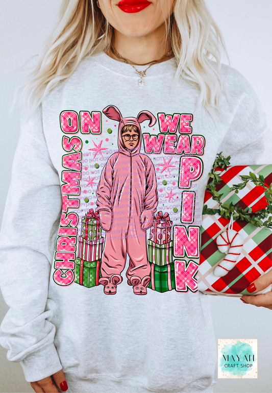 Person wearing a white sweatshirt with a Christmas-themed graphic and text.