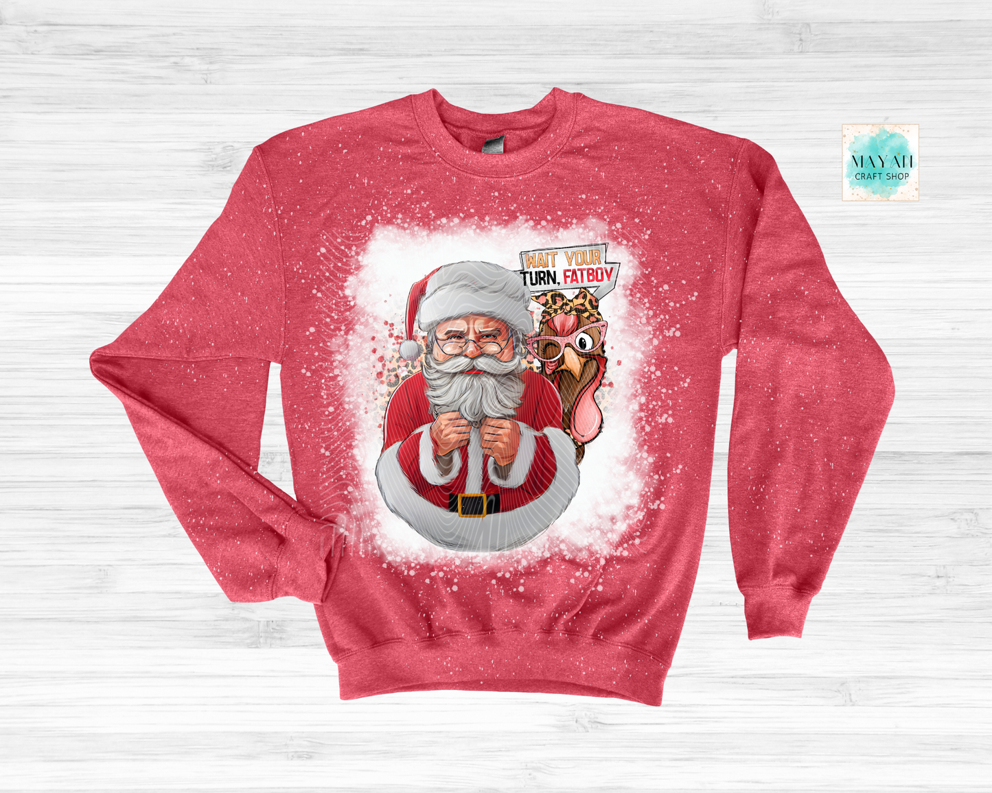 Red sweatshirt with Santa Claus graphic and reindeer on a light gray background