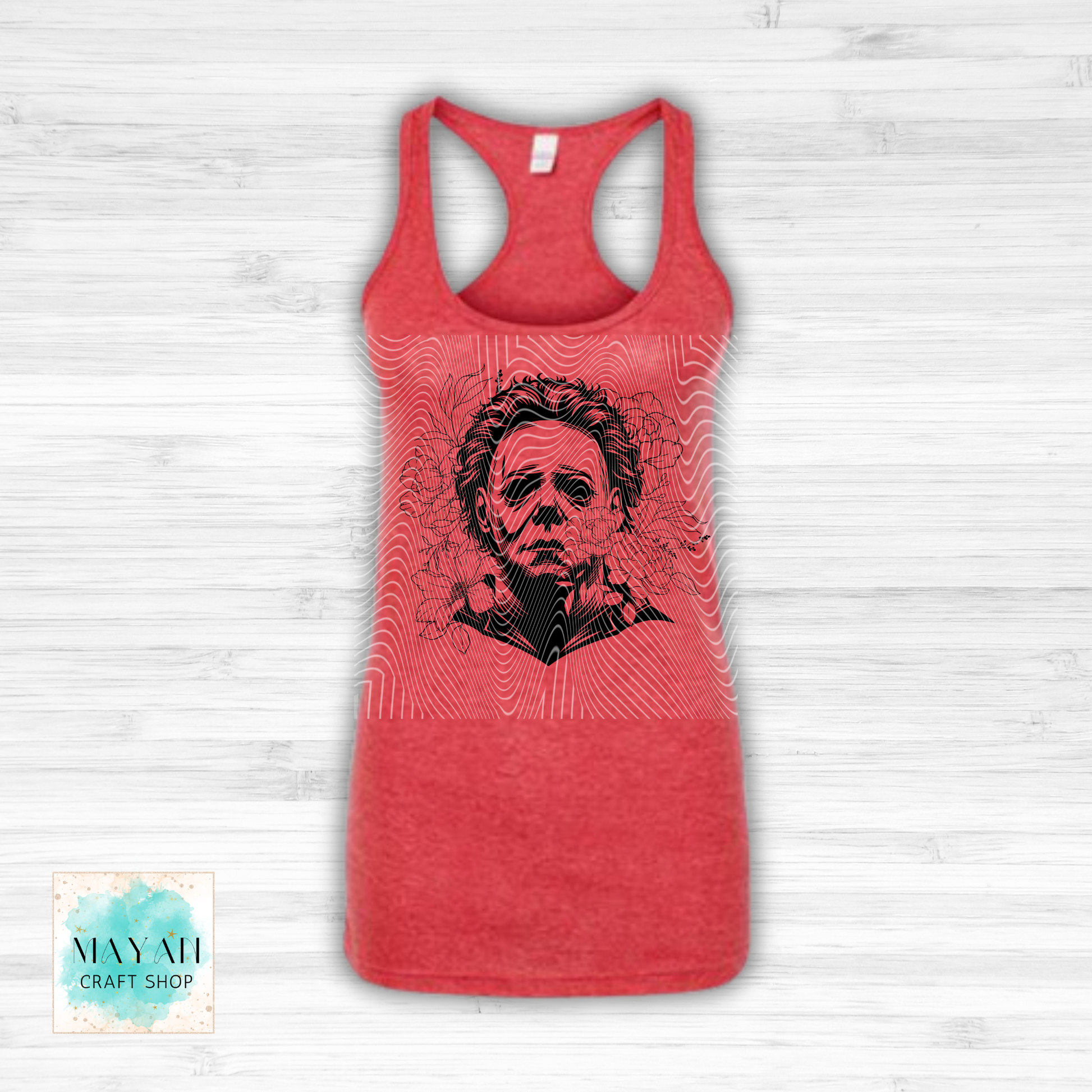 Red tank top with black graphic design on a white wooden surface.