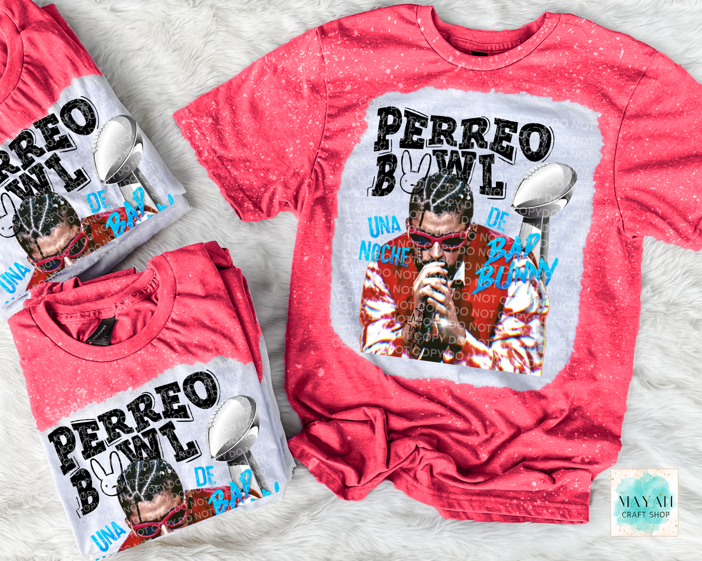 Two red t-shirts with graphic designs and text on a textured surface.