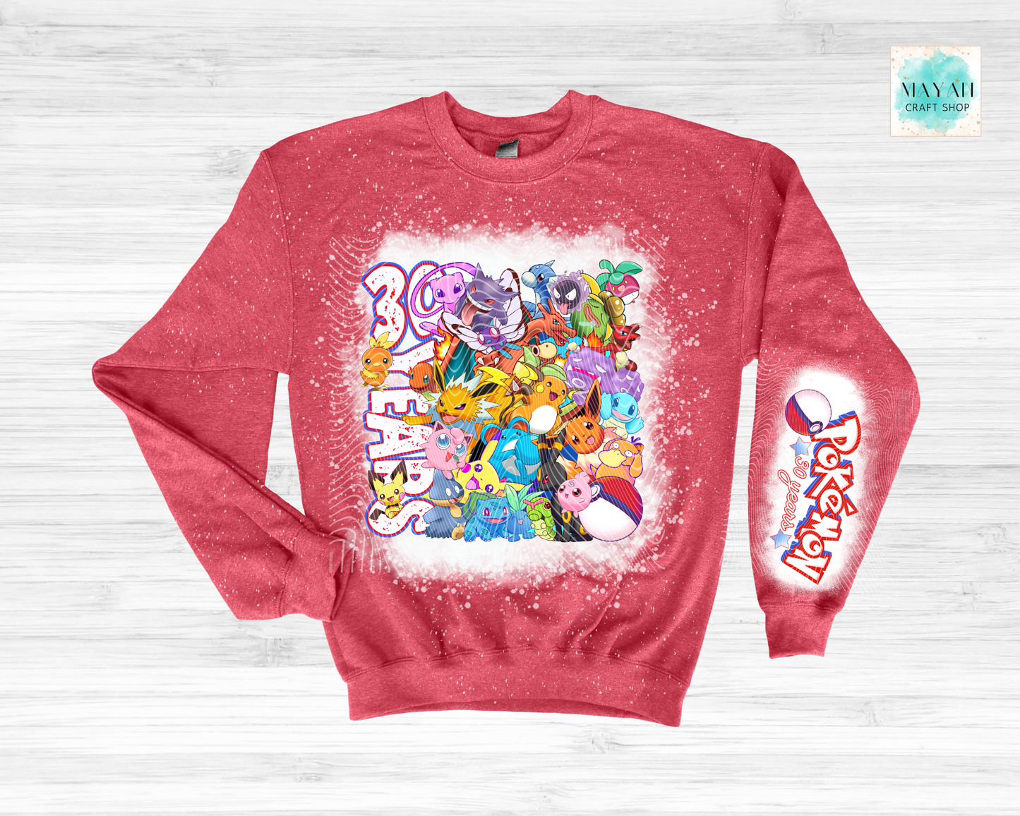 Red sweatshirt with colorful graphic design on a light gray background