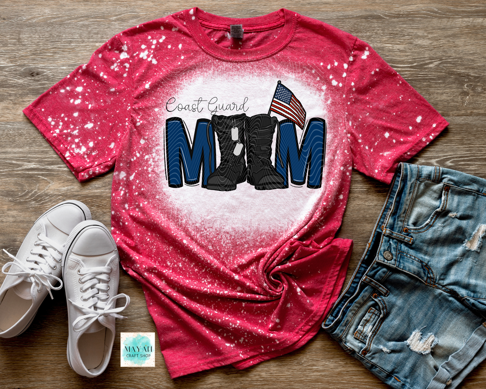 Red t-shirt with military mom text and boots graphic on a wooden surface with shoes and shorts.