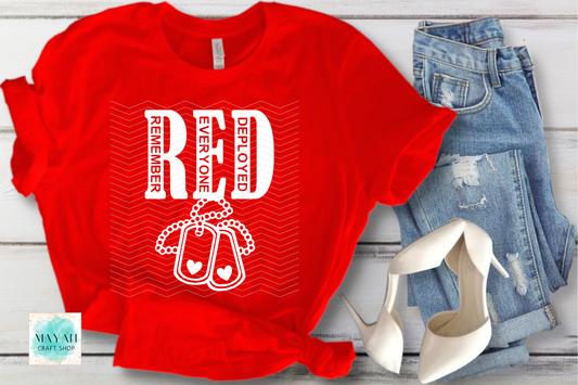 Red t-shirt with 'Remember Everyone Deployed' design, paired with jeans and high heels on a wooden surface.