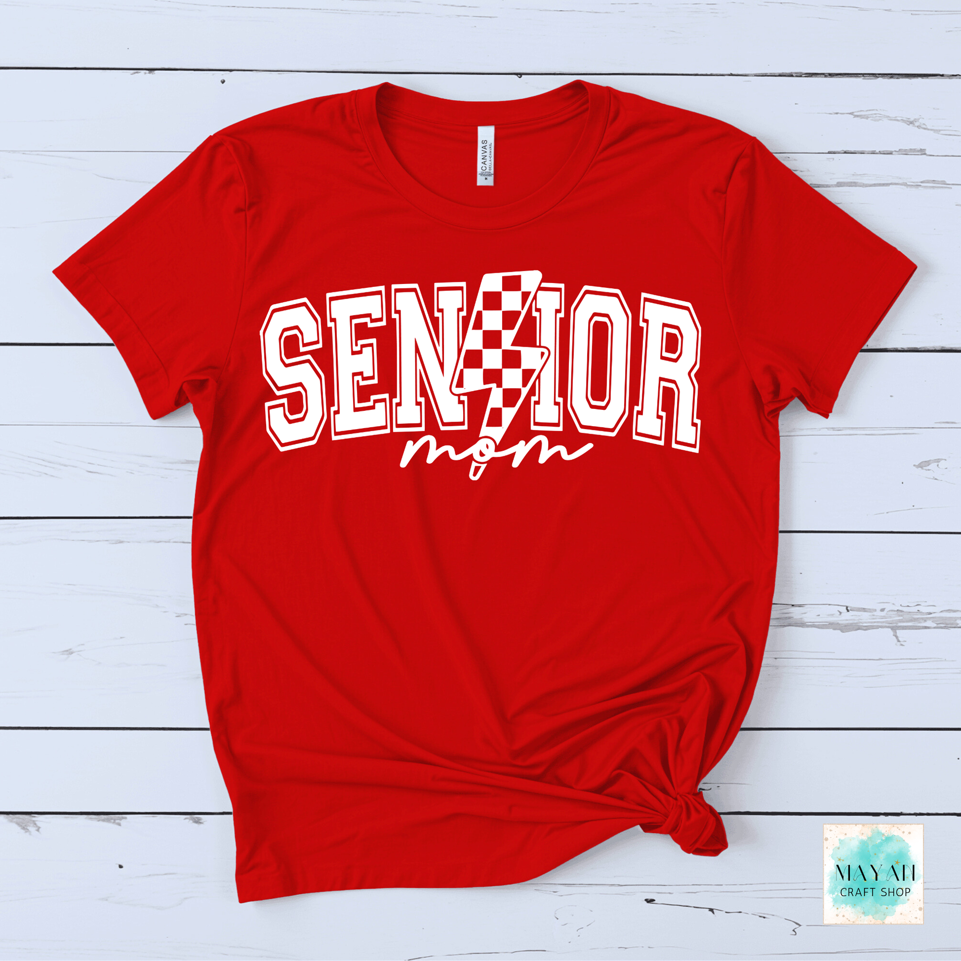 Red t-shirt with 'Senior Mom' text on a wooden surface