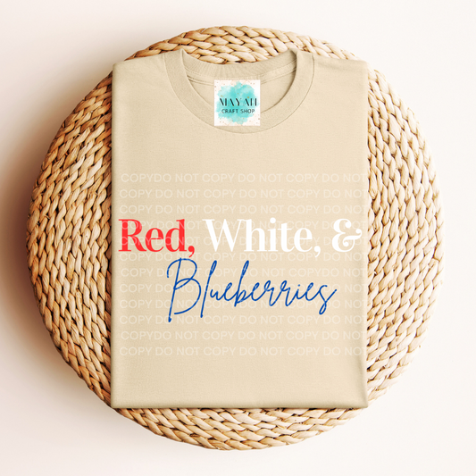 Beige t-shirt with 'Red, White & Blueberries' text on a woven mat