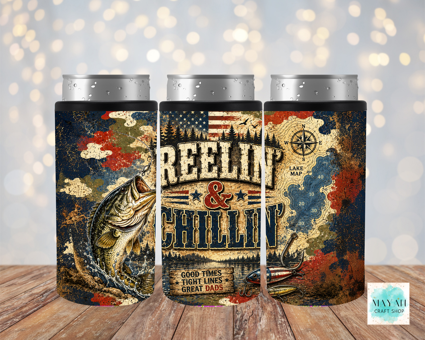 Three cylindrical coolers with 'Reeling & Chillin' design on a wooden surface.